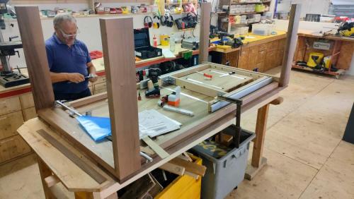 a man working on a table in a workshop at Nisihof, Landluft in Oberkirch