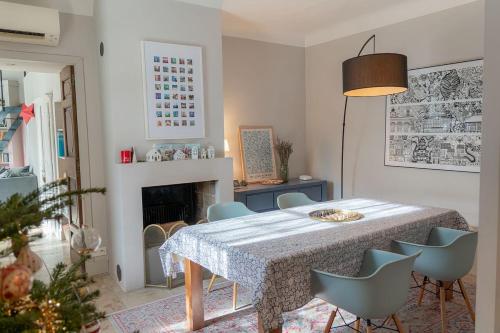 a dining room with a table and chairs and a fireplace at Maison avec piscine in Aix-en-Provence