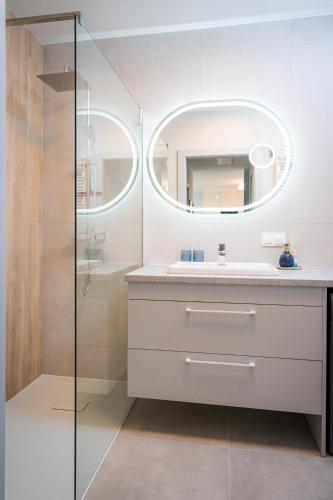 a bathroom with a sink and a mirror at Centaurus 49 by RENT4YOU in Olsztyn