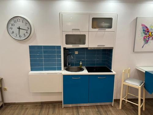 a kitchen with a sink and a clock on the wall at Studio Lorena in Mali Lošinj