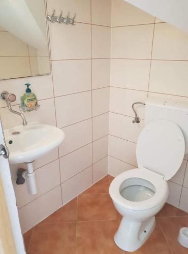 a bathroom with a toilet and a sink at Robinson Medvidina Bay in Zastražišće