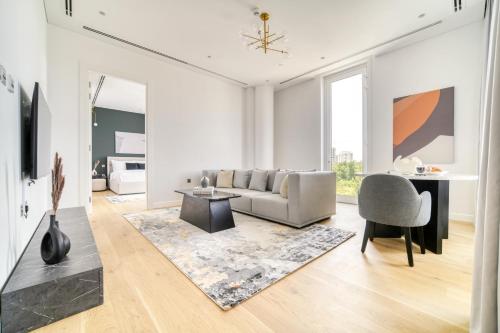 a living room with a couch and a table at Stella Stays Al-Barari in Dubai