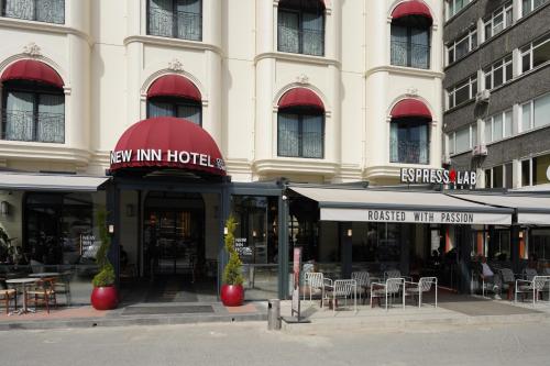 a hotel with tables and chairs in front of a building at New Inn Hotel Old Town in Istanbul