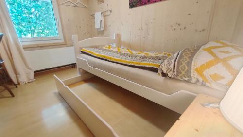 a bed in a small room with a window at Nisihof, Landluft in Oberkirch