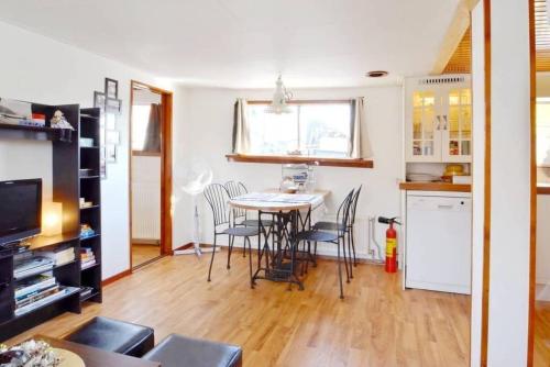 a kitchen and dining room with a table and chairs at Houseboat Captain's Quarters in Harbour Amsterdam in Amsterdam