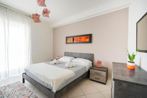 a bedroom with a large bed and a table at Mistral Suite Apartment - free private car park in Bari