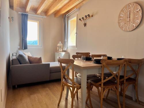 a living room with a table and a couch at Antica Corte - Lake view in Montinelle