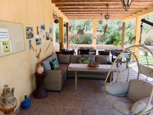 a porch with a couch and a table and chairs at Casita Vista Alegre in Castril