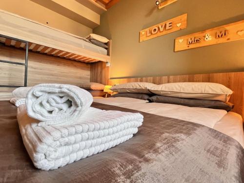 a bedroom with two beds with towels on them at Antica Corte - Lake view in Montinelle