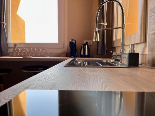 a kitchen counter top with a sink in a kitchen at Antica Corte - Lake view in Montinelle