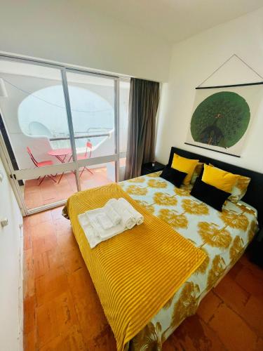 a bedroom with a bed with a yellow blanket at Boutique Two Bedrooms Apartament Praia Da Oura in Albufeira