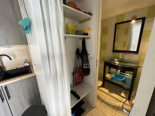 - un couloir avec une chambre dotée d'un lavabo et d'un miroir dans l'établissement Charmante villa climatisée T2 mezzanine, 6 pers, terrasse ensoleillée, proche plage et commerces - FR-1-106-37, à Saint-Cyprien