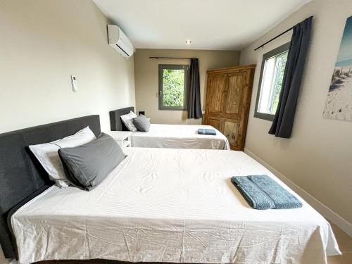two beds in a room with two windows at Villa Peralta Girona City w above ground Pool in Girona