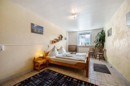 a bedroom with a bed and a table and chairs at Ferienwohnung Wiesental in Meisburg