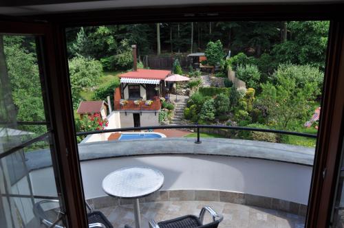 a view of a garden from the balcony of a house at Apartmán Bílá Hora - Roudná in Plzeň