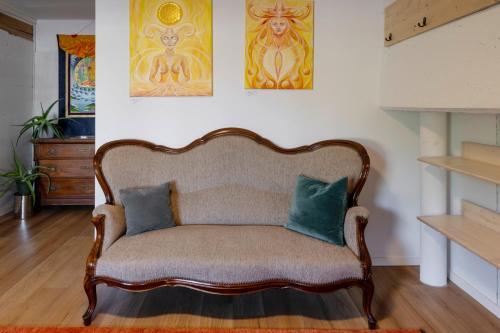 a couch with two pillows sitting in a living room at Nisihof, Buurenzimmer Family or Single in Oberkirch