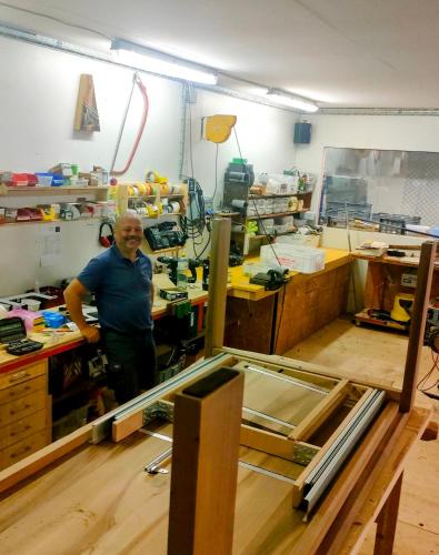 a man in a workshop working on a piece of wood at Nisihof, Buurenzimmer Family or Single in Oberkirch