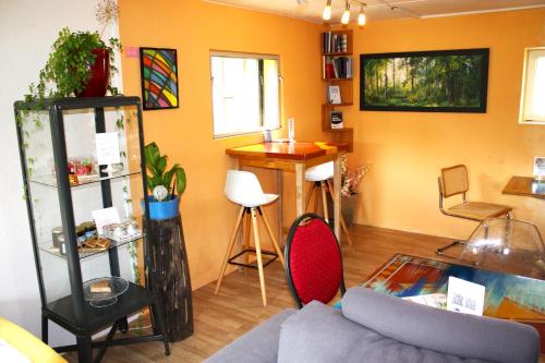 a living room with a couch and a table at Nisihof, Buurenzimmer Family or Single in Oberkirch