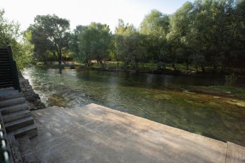 a view of a river with trees in the background at Villa Paradise On The River in Blagaj