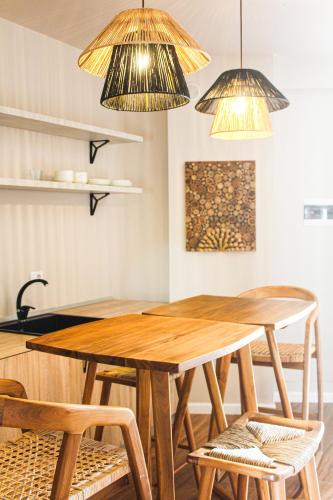 a dining room with a wooden table and chairs at Azar Luxury Suites in Vlorë