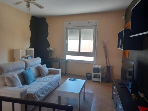 a living room with a couch and a table at Apartamento Bahia in Algeciras