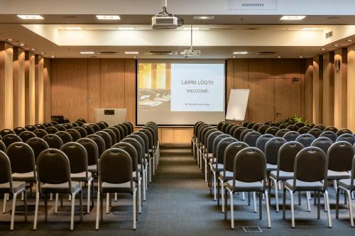 a lecture room with chairs and a projector screen at Tallink Hotel Riga in Rīga