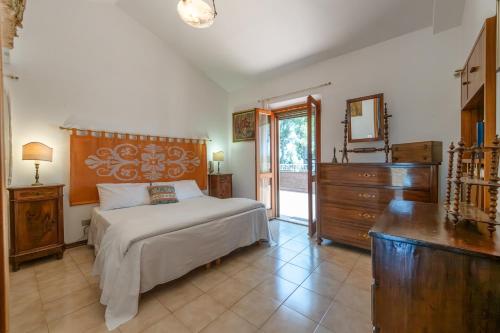 a bedroom with a bed and a dresser and a mirror at Villa Stipa with pool by Quokka 360 - Close to Riviera delle Palme in Offida