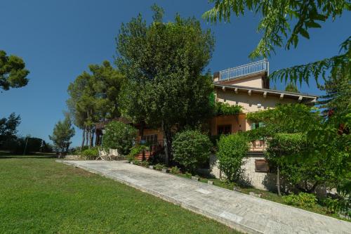 a house with a walkway in front of it at Villa Stipa with pool by Quokka 360 - Close to Riviera delle Palme in Offida