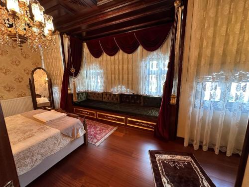 a bedroom with a bed and a large window at TAHTAKALE KONAK HOTEL Private & Luxury in Bursa