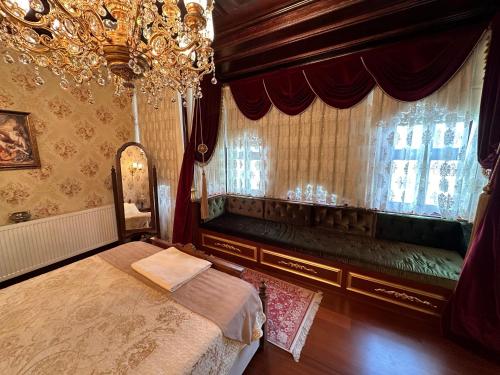 a bedroom with a bed and a window at TAHTAKALE KONAK HOTEL Private & Luxury in Bursa