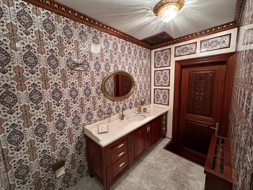 a bathroom with a sink and a mirror at TAHTAKALE KONAK HOTEL Private & Luxury in Bursa