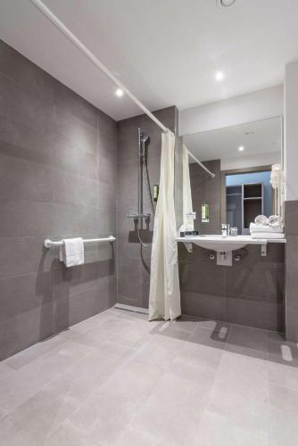 a bathroom with a shower and a sink at Best Western Hotel Kiefersfelden in Kiefersfelden