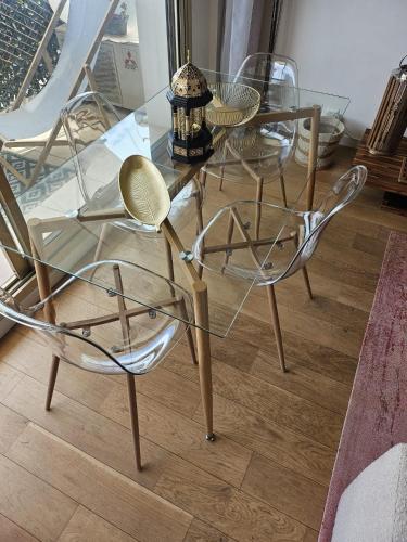 a glass table and chairs in a room at Le Duplex in Antibes