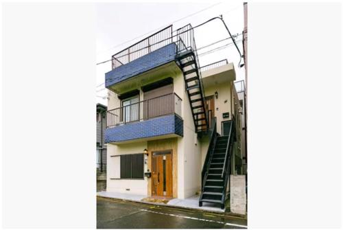 a building with a spiral staircase on the side of it at 64, Shiomi , Second floor of the apartment, 潮見2F in Tokyo