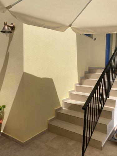 a staircase in a building with a stair case at SOL Aegina Town House in Egina