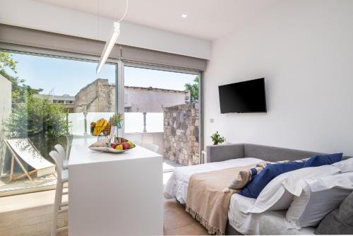 a bedroom with a bed and a large window at Michelangelo City Luxury Lodge in Kos Town