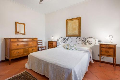 a bedroom with two beds and a dresser at Villa Acquaviva With Pool In Perugia in Binami