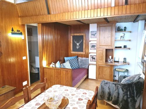 a living room with a table and a couch at Maison Seguret 50mt from sky lifts in Sauze dʼOulx
