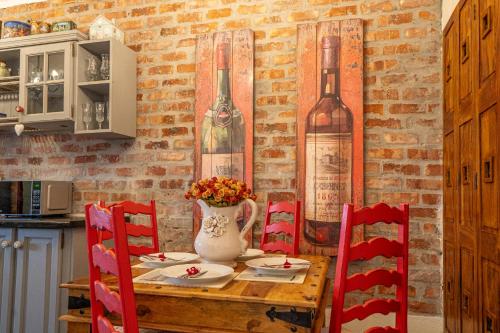 a table with chairs and a vase with flowers on it at Sir Napier Boutique Guest House in Napier