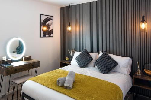 a bedroom with a large bed with a yellow blanket at 1 Bedroom apartment Kentish town in London