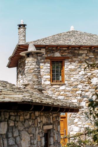 an old stone building with a window on it at Trees Ikies in Mouresi