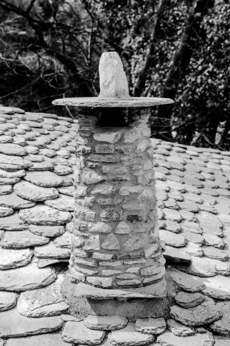 a hat sitting on top of a stone wall at Trees Ikies in Mouresi