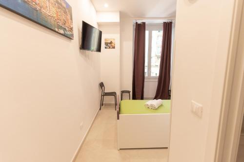 a small room with a desk and a window at Adam Eric in La Spezia