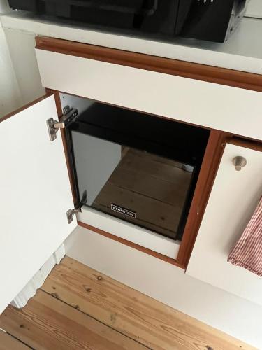 a microwave oven in a drawer in a kitchen at Townhouse in Odense