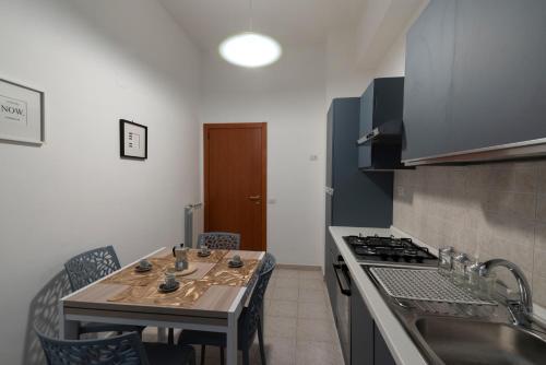a kitchen with a table and a stove top oven at Casa Giulia in Castellammare di Stabia