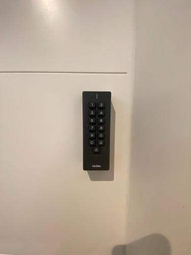 a black remote control hanging on a white cabinet at JetaHome in Rosenheim