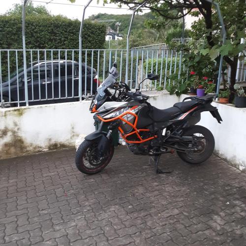 a motorcycle parked next to a fence at AceroRosso B&B in Salerno