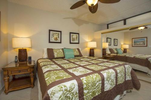 a bedroom with two beds and a ceiling fan at Kihei Akahi Resort - Unit C313 in Wailea