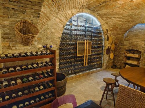 a wine cellar with a large wall of wine bottles at La casa di Chiara in Diano dʼAlba