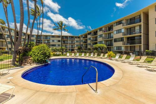 a pool in the courtyard of a apartment building at Kanai A Nalu 302 in Wailuku